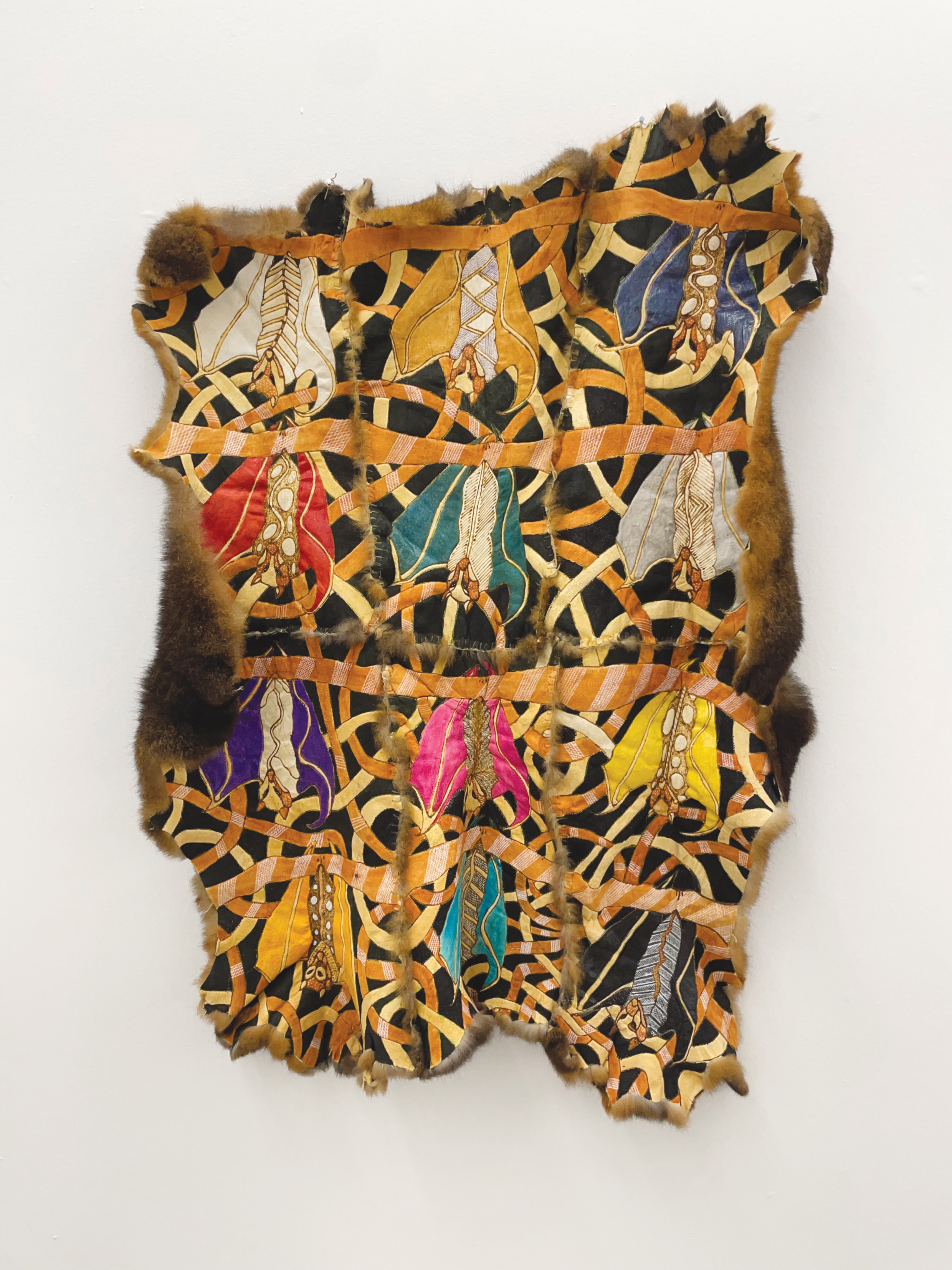 Gina Bundle, “Bangu’s (flying fox) Cloak,” 2022, ochre and paint on possum skins, photo by Chris Cottrell.