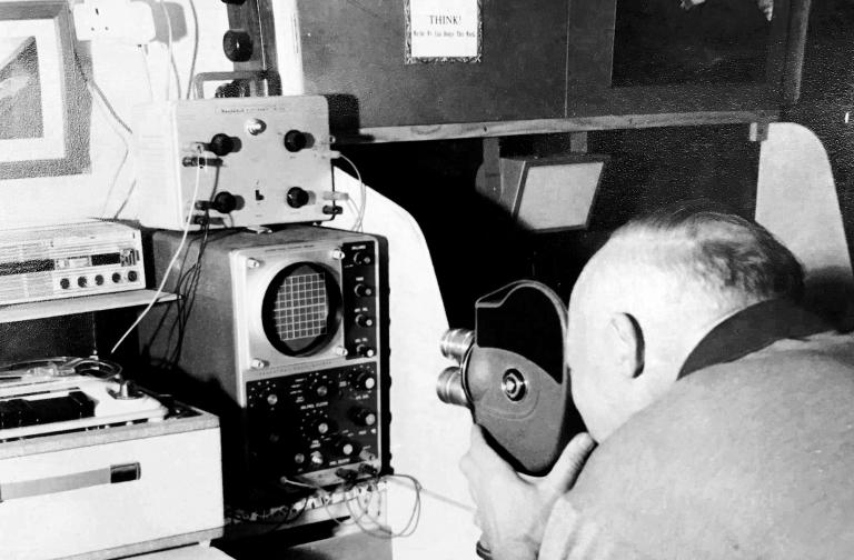 Photo of John Hooper, a founding member of the Devon Speleological Society, analyzing bat recordings at his studio in Surrey.